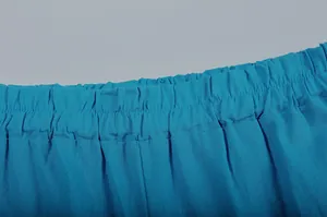 Detailed macro view of the elastic high waistband on these teal blue wide-leg casual pants