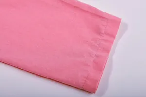 Detailed macro view showing the pink fabric texture and stitching of the sleeve hem.