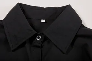 Close-up detail showing the collar and button of a black women's long sleeve shirt
