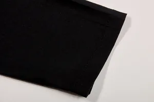 Close-up detail showing the black fabric stitching on casual women's shirt and pants set
