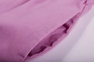 Macro detail shot showing the side pocket and fabric texture of purple wide-leg pants