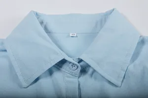 Close-up of a light blue button-up shirt collar detail showing size S label and stitching
