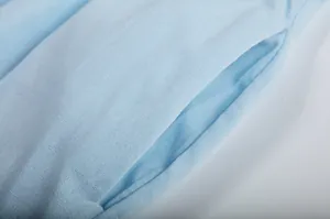 Close-up detail of side pocket on light blue wide-leg pants from casual two-piece outfit
