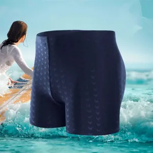 Side view of navy blue men's swim trunks with subtle wave pattern in beach setting