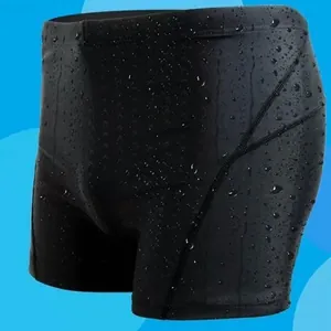 Detail view of quick-dry black swim trunks with visible water droplets on fabric.