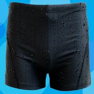 Close-up detail view of black quick-dry men's swim trunks featuring water droplets texture