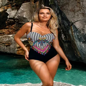 Detail view of colorful tribal print and black fabric on a women's plus size swimsuit