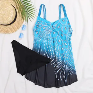Plus size tankini swimsuit with peacock print and skirted top on white background