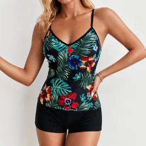 Detail of two-piece floral tankini swimsuit with tropical print and black boy shorts