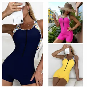 One-piece zip-up athletic swimsuit with geometric pattern trim in navy, pink, and yellow.