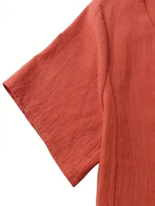 Detailed view of the rust red cotton linen fabric texture and short sleeve
