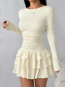 Close-up of elegant cream long-sleeved slim-fit mini dress featuring tiered ruffles