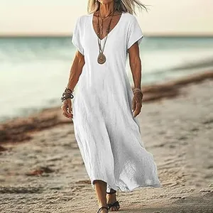 Elegant white V-neck loose cotton linen maxi dress for women in a beach setting.