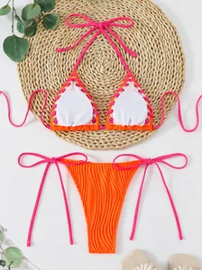 Vibrant neon orange and pink halter neck bikini set with stylish ribbed jacquard texture.