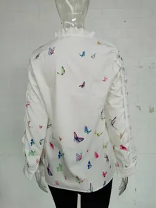 Back view of elegant white blouse with ruffle collar, lace trim and colorful butterfly print.