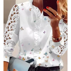 Detailed view of white butterfly print blouse featuring elegant lace sleeves and ruffles