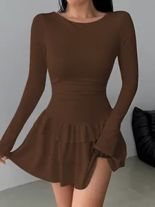 Detailed view of the slim-fit brown long-sleeved dress featuring a tiered ruffle hem