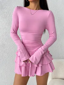 A stylish pink long-sleeved slim-fit dress featuring a delicate layered ruffled hem design.