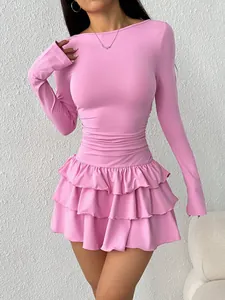 Detailed view of a pink long-sleeve dress with a tiered ruffled skirt and slim fit.