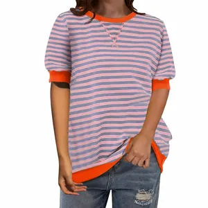 Close-up of women's striped t-shirt with vibrant orange contrast trim on crew neck and cuffs.