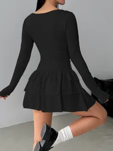 Back view detail of a chic black long-sleeve slim-fit dress with tiered ruffle skirt layers