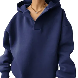Close-up detail of a navy blue oversized V-neck hooded sweatshirt with ribbed cuffs