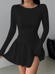 Detail of a slim-fit black long-sleeved dress featuring a layered tiered ruffle hemline.