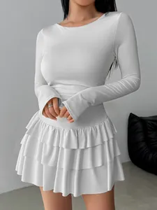 Elegant detail view of a white long-sleeved slim-fit mini dress with tiered ruffles
