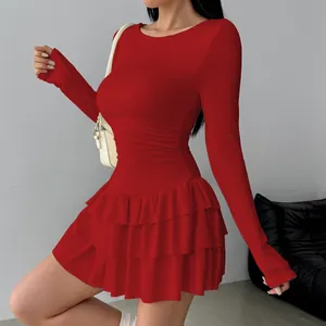 Detailed view of red tiered ruffle mini dress with long sleeves and pleated waistline