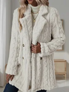 Close-up of white plush mid-length coat with notched lapel and soft cable knit texture.