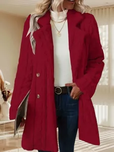 Close-up view of red plush textured coat featuring double-breasted buttons and lapel collar