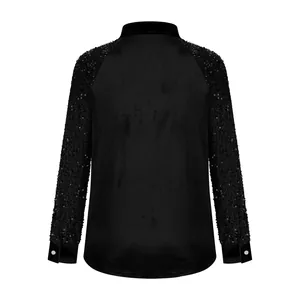 Detailed back view of women's loose black velvet shirt featuring sparkly sequined sleeves
