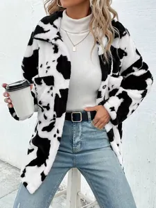 Detailed view of a cozy cow print plush jacket featuring a lapel and button closure