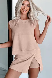 Detail shot of a woman wearing a tan sleeveless cotton loungewear set with a wrap skort.
