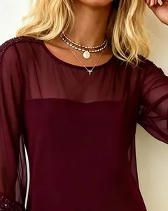 Close-up detail of burgundy mesh sheer dress featuring elegant sequin shoulder accents.