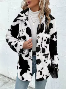 Detailed view of women's cow print plush jacket with a cozy lapel and button closure.