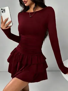 Detail view of a burgundy slim fit long sleeve mini dress with elegant ruffled hem