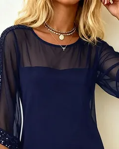 Detail showing sheer mesh upper and sequin embellishments on a navy blue dress