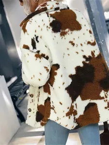 Detailed side view of a warm cow print plush jacket with soft and fuzzy texture