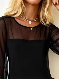 Elegant black women's dress with sexy sheer mesh panel and sequin shoulder details