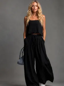 Casual women's summer two-piece set featuring a black tank top and flowy wide-leg trousers