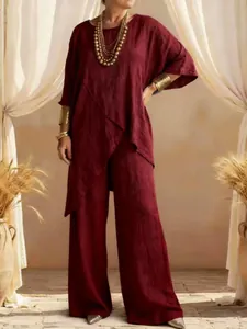 Detailed view of burgundy cotton linen two-piece set featuring a tunic with irregular hem.