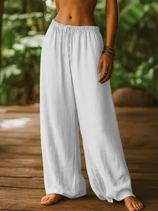 Detailed texture of white cotton linen fabric on loose-fit wide-leg casual trousers
