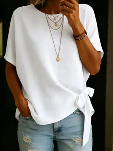 Detail view of a white loose-fitting T-shirt featuring a stylish side knot detail.