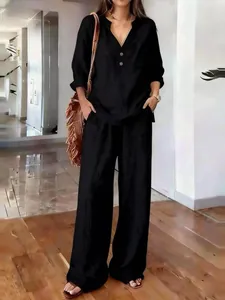 Detail of casual two-piece black loungewear set with long sleeve V-neck top and pants