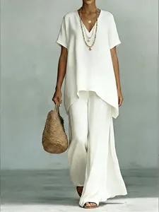 Elegant white linen two-piece set featuring V-neck top and matching wide-leg trousers