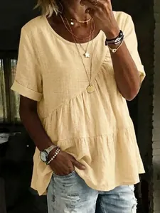 Detailed view of women's yellow tiered cotton linen t-shirt with ruffled hem and round neck