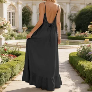 Detailed view of elegant backless black sleeveless summer maxi dress in garden setting