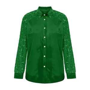 Close-up detail of a stylish emerald green velvet shirt with sparkling sequin sleeves.