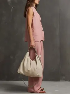 Model wearing a pink cotton linen sleeveless vest and wide-leg pants two-piece outfit